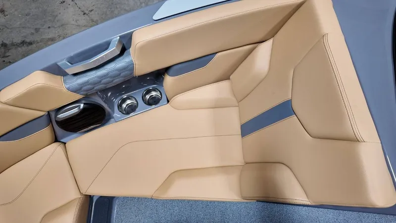 Slide: The Image of Interior of 2026 MasterCraft XT23 with beige upholstery and cup holders. - 30