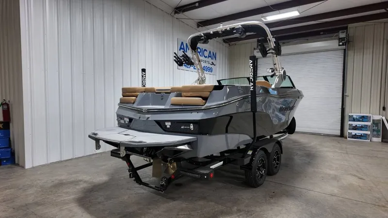 Slide: The Image of 2026 MasterCraft XT23 boat parked in warehouse. - 4
