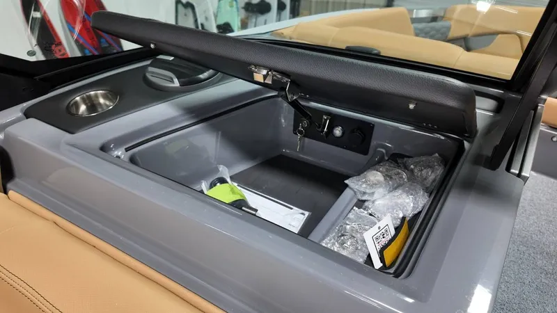 Slide: The Image of Interior of 2026 MasterCraft XT23 with storage compartment and cup holder. - 46