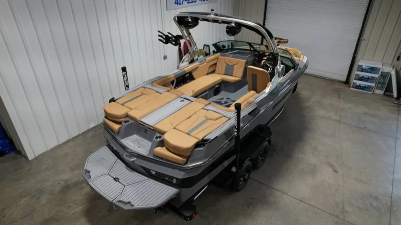 Slide: The Image of 2026 MasterCraft XT23 boat parked in a garage. - 5