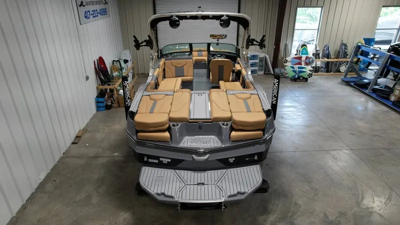 Slide: The Image of 2026 MasterCraft XT23 boat in a warehouse, interior view. - 8
