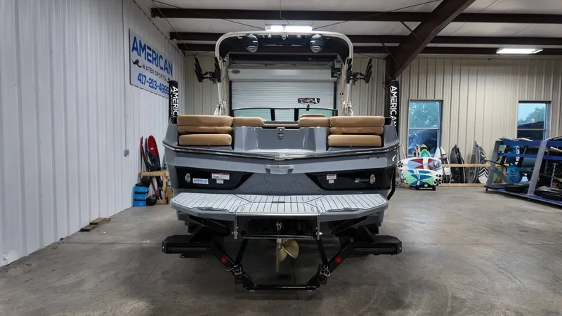 Slide: The Image of Rear view of a 2026 MasterCraft XT23 boat in a warehouse. - 9