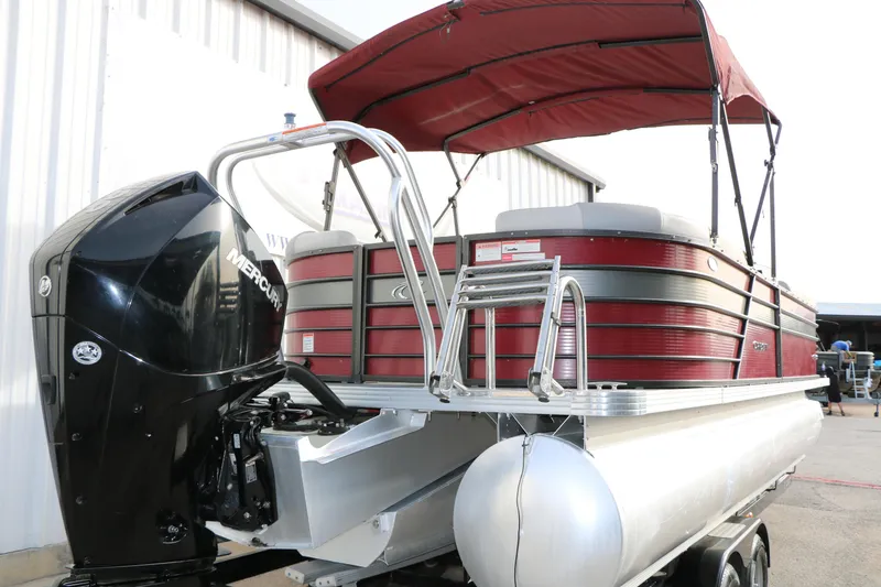 Slide: The Image of 2019 Crest II 240 SL pontoon boat with red canopy and Mercury outboard motor. - 14