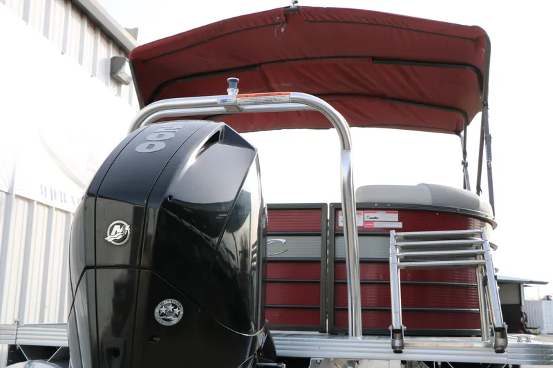 Slide: The Image of 2019 Crest II 240 SL pontoon boat with red canopy and powerful outboard motor. - 15