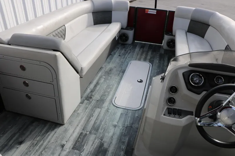 Slide: The Image of 2019 Crest II 240 SL pontoon boat interior with gray seating and modern dashboard. - 32