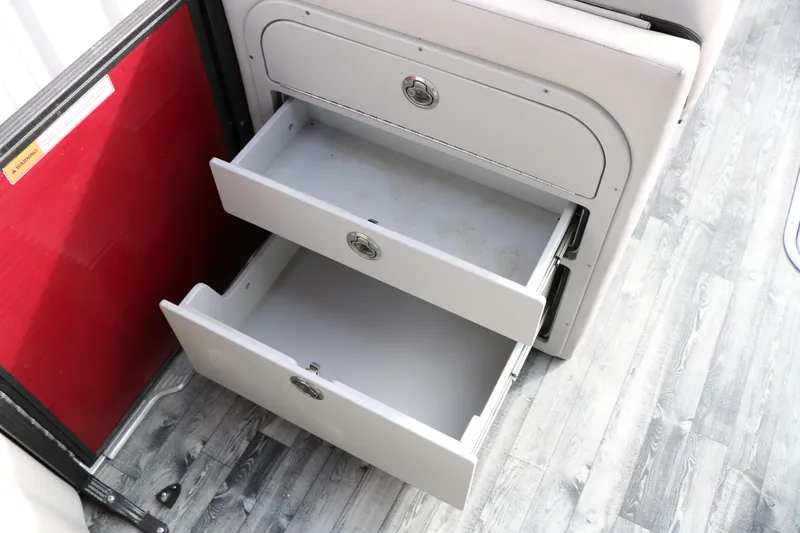 Slide: The Image of Open storage drawers in a 2019 Crest II 240 SL boat interior. - 34