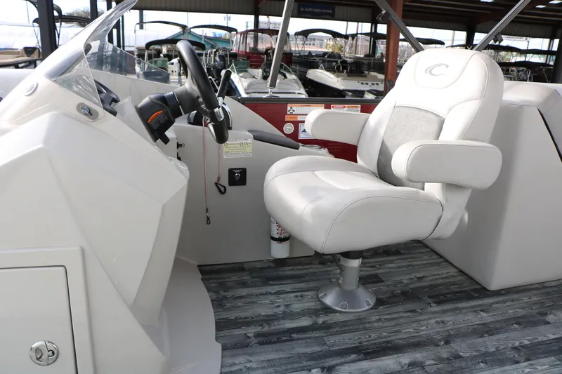 Slide: The Image of Captain's chair and helm of 2019 Crest II 240 SL pontoon boat. - 35