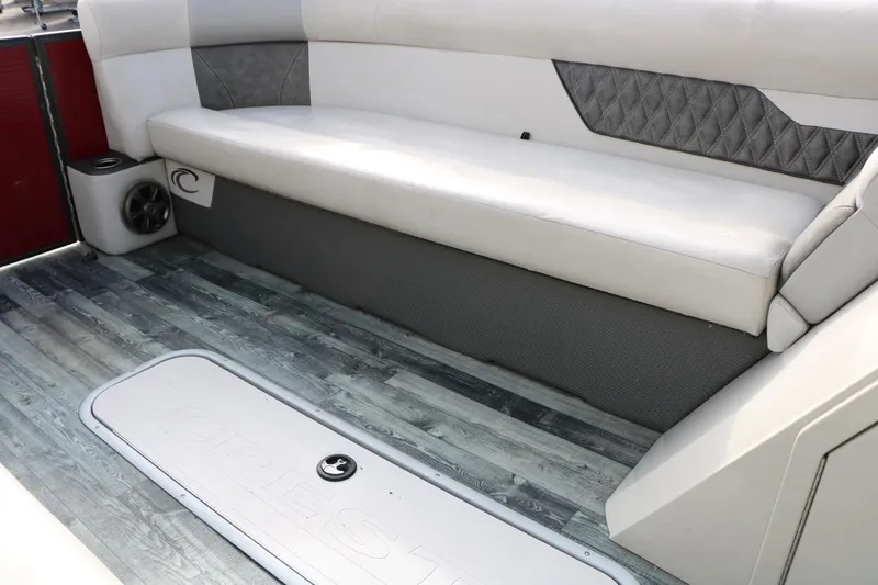 Slide: The Image of 2019 Crest II 240 SL boat interior with white seating and wood-style flooring. - 36