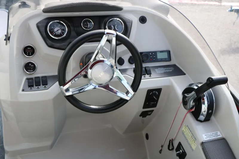 Slide: The Image of 2019 Crest II 240 SL boat dashboard with steering wheel and control panel. - 37
