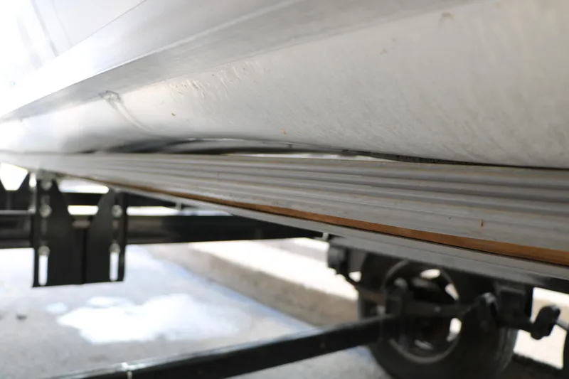 Slide: The Image of Underneath view of a 2019 Crest II 240 SL pontoon boat on a trailer. - 44