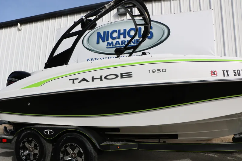 Slide: The Image of 2017 Tahoe 1950 boat with green accents on trailer at Nichols Marine. - 12
