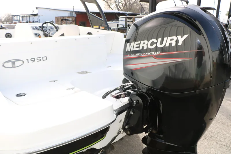 Slide: The Image of 2017 Tahoe 1950 boat with Mercury FourStroke engine, white interior, outdoor setting. - 15