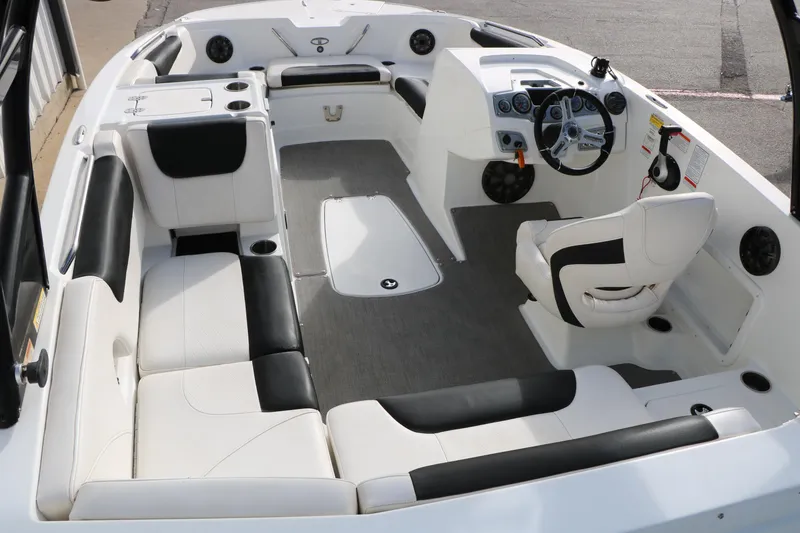 Slide: The Image of Interior of 2017 Tahoe 1950 boat with white and black seating, steering wheel, and dashboard. - 17