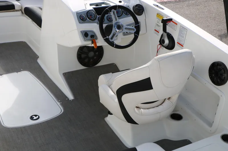 Slide: The Image of Interior of a 2017 Tahoe 1950 boat featuring steering wheel and captain's chair. - 18