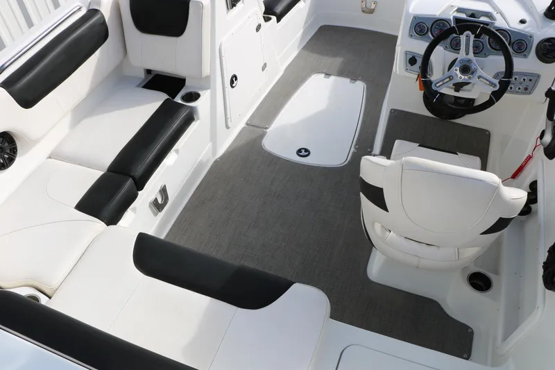 Slide: The Image of Interior of a 2017 Tahoe 1950 boat with white and black seating. - 21