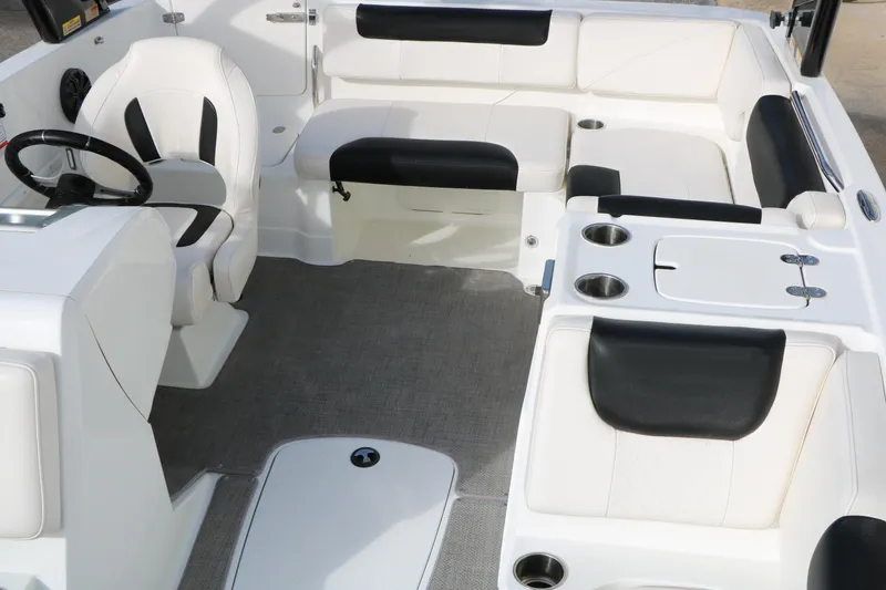 Slide: The Image of Interior of a 2017 Tahoe 1950 boat with white and black seating. - 23
