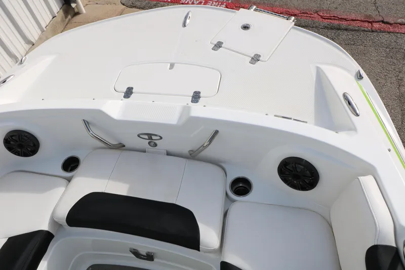 Slide: The Image of 2017 Tahoe 1950 boat interior with white seating and built-in speakers. - 25