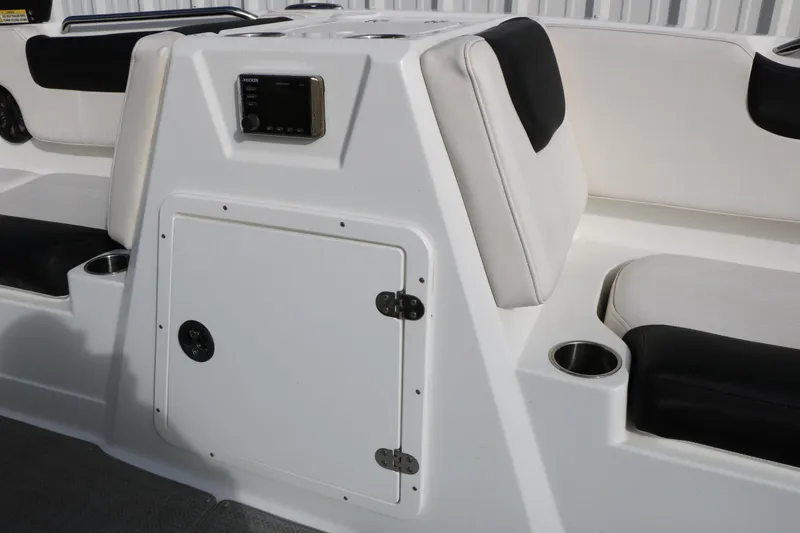 Slide: The Image of 2017 Tahoe 1950 boat interior with white and black seating, cup holders, and control panel. - 26