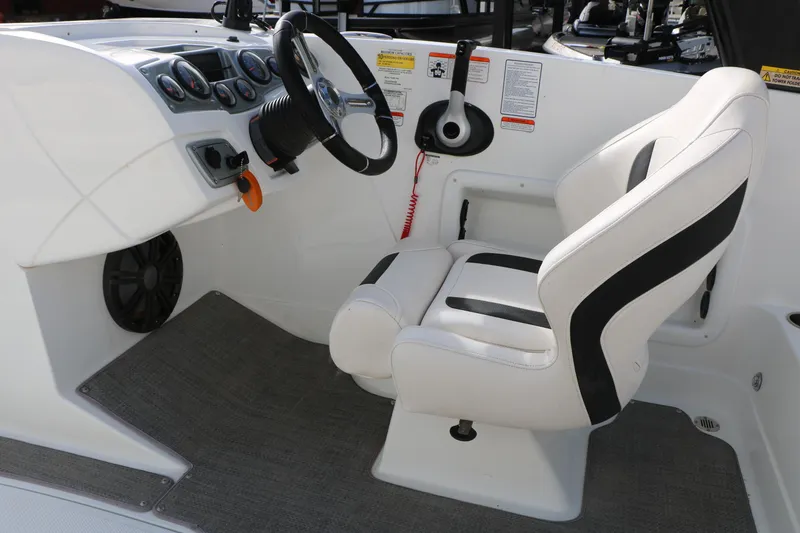 Slide: The Image of Cockpit of 2017 Tahoe 1950 boat with steering wheel and white captain's chair. - 29
