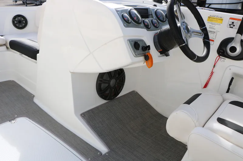 Slide: The Image of Interior of a 2017 Tahoe 1950 boat, featuring steering wheel and dashboard controls. - 31