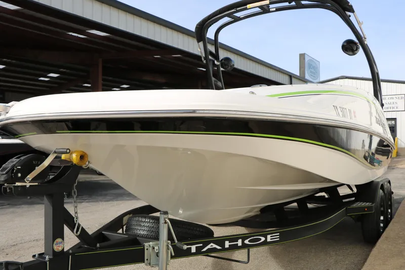 Slide: The Image of 2017 Tahoe 1950 boat on trailer, displayed outdoors at a dealership. - 7