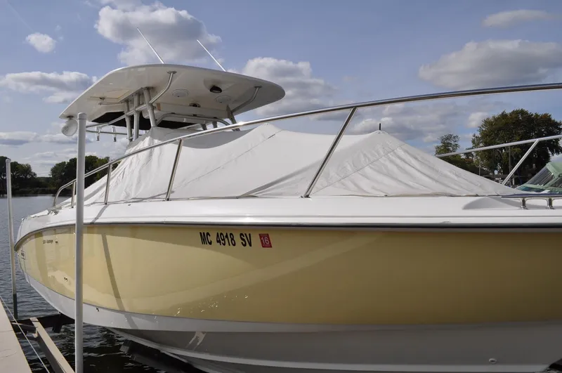 Slide: The Image of 2006 Boston Whaler 320 Outrage boat docked, side view. - 1