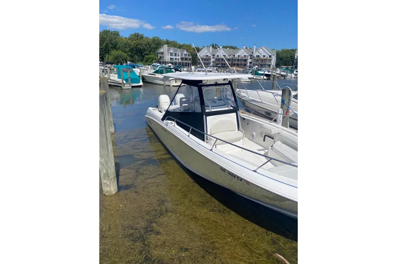 Slide: The Image of 2006 Boston Whaler 320 Outrage docked at a marina on a sunny day. - 5