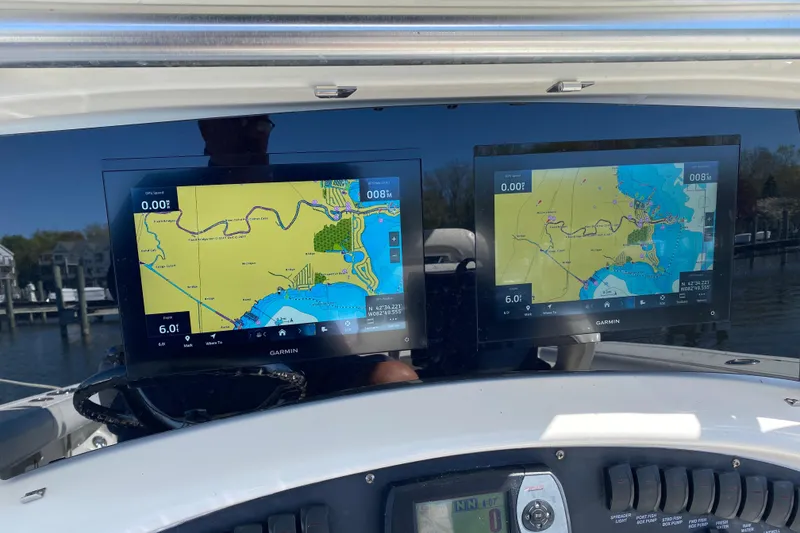 Slide: The Image of Dual Garmin navigation screens on a 2006 Boston Whaler 320 Outrage boat dashboard. - 8
