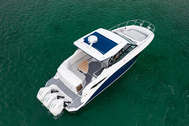 Slide: The Image of 2020 Sea Ray Sundancer 320 Outboard cruising on clear green water. - 10