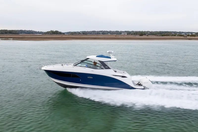 Slide: The Image of 2020 Sea Ray Sundancer 320 Outboard cruising on calm waters. - 14