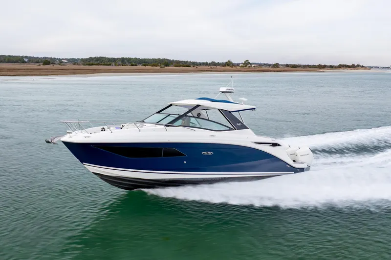 Slide: The Image of 2020 Sea Ray Sundancer 320 Outboard cruising on calm waters. - 15