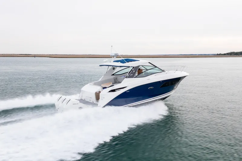 Slide: The Image of 2020 Sea Ray Sundancer 320 Outboard cruising on open water. - 19
