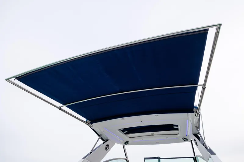 Slide: The Image of 2020 Sea Ray Sundancer 320 Outboard with blue canopy, viewed from below. - 22