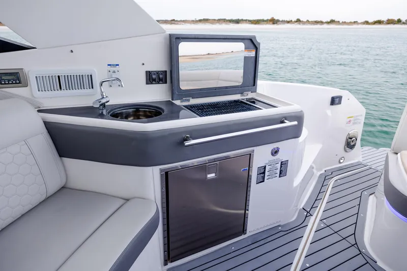 Slide: The Image of Luxury outdoor kitchen on 2020 Sea Ray Sundancer 320 Outboard yacht, featuring sink and grill. - 25