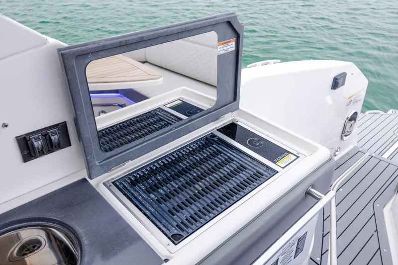 Slide: The Image of Outdoor grill on 2020 Sea Ray Sundancer 320 Outboard boat, near water. - 26