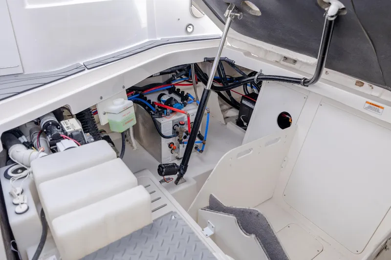 Slide: The Image of 2020 Sea Ray Sundancer 320 Outboard engine compartment with visible wiring and components. - 29