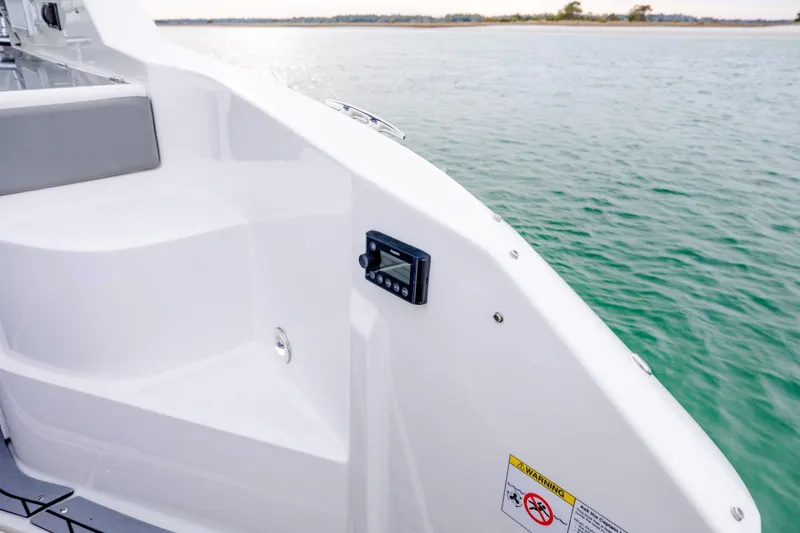 Slide: The Image of 2020 Sea Ray Sundancer 320 Outboard boat deck with control panel, near calm waters. - 42