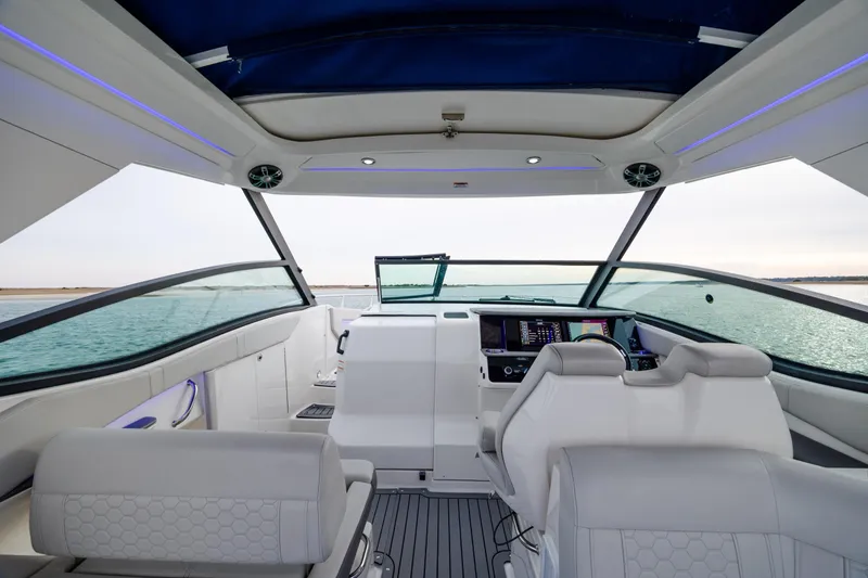 Slide: The Image of 2020 Sea Ray Sundancer 320 Outboard cockpit with modern controls and panoramic water view. - 44