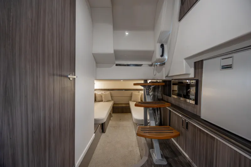 Slide: The Image of Interior cabin of 2020 Sea Ray Sundancer 320 Outboard, featuring modern design and cozy seating. - 52