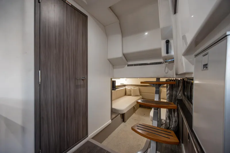 Slide: The Image of 2020 Sea Ray Sundancer 320 Outboard interior with modern cabin and wooden accents. - 53