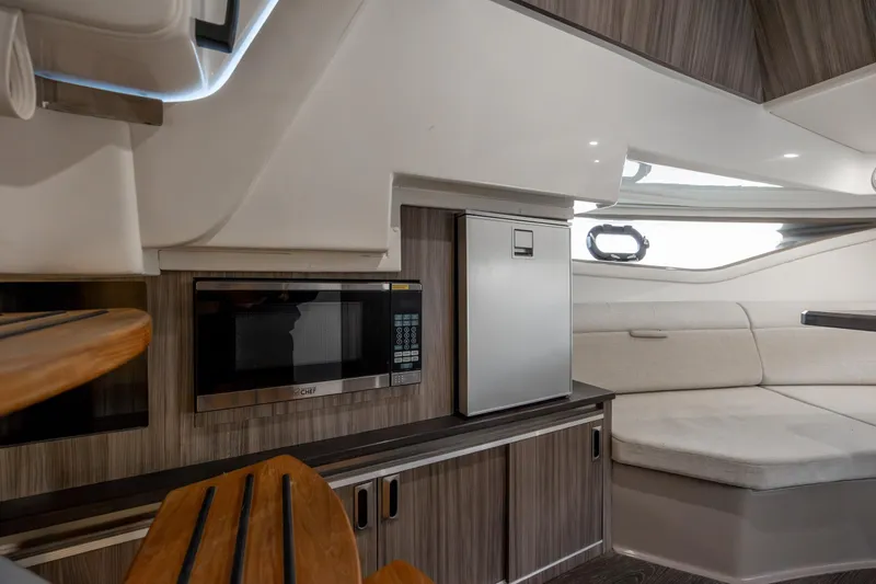 Slide: The Image of 2020 Sea Ray Sundancer 320 Outboard interior with kitchenette and seating area. - 54