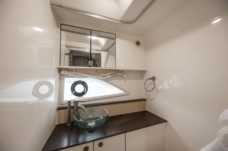 Slide: The Image of 2020 Sea Ray Sundancer 320 Outboard bathroom with modern sink and mirror. - 57