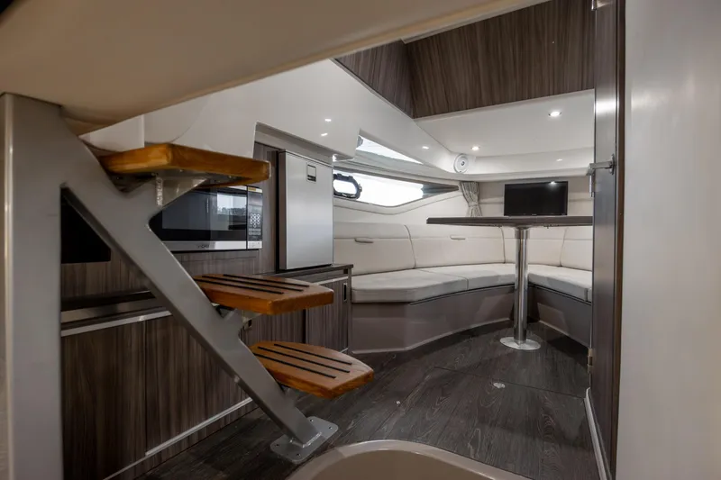 Slide: The Image of Interior of 2020 Sea Ray Sundancer 320 Outboard, featuring modern seating and wooden accents. - 61