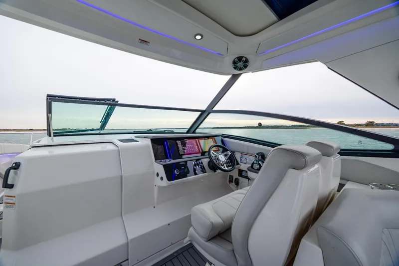 Slide: The Image of 2020 Sea Ray Sundancer 320 Outboard helm with modern controls and panoramic water view. - 63