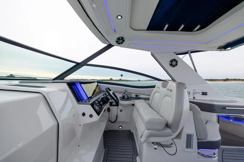 Slide: The Image of 2020 Sea Ray Sundancer 320 Outboard cockpit with modern helm and luxurious seating. - 64