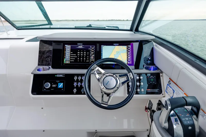Slide: The Image of 2020 Sea Ray Sundancer 320 Outboard helm with advanced navigation and control systems. - 65