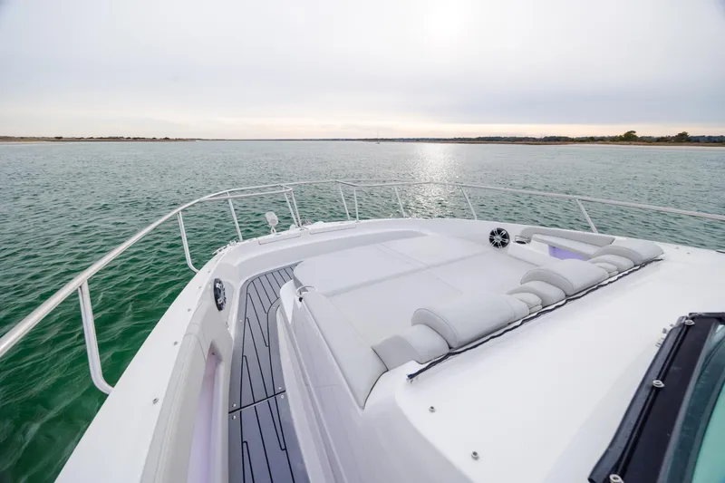 Slide: The Image of 2020 Sea Ray Sundancer 320 Outboard cruising on calm waters, featuring spacious deck seating. - 67