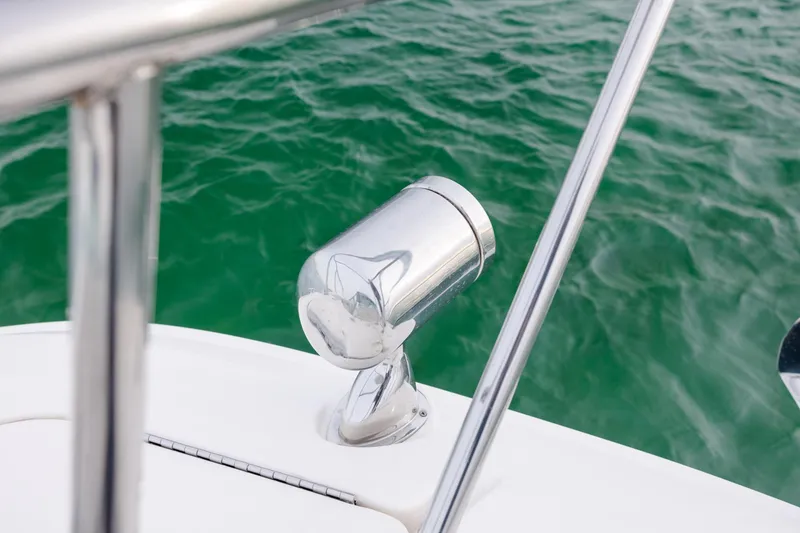 Slide: The Image of 2020 Sea Ray Sundancer 320 Outboard spotlight on deck, overlooking green water. - 69