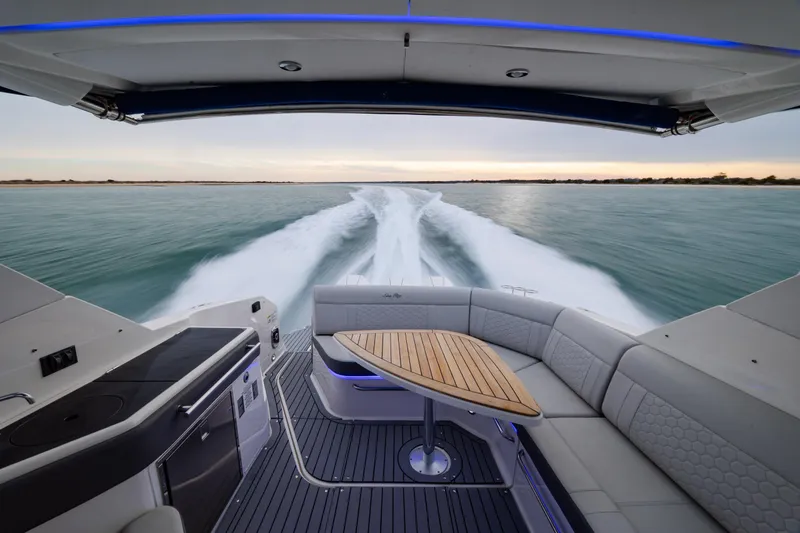 Slide: The Image of 2020 Sea Ray Sundancer 320 Outboard cruising on open water, featuring luxurious seating and sleek design. - 72