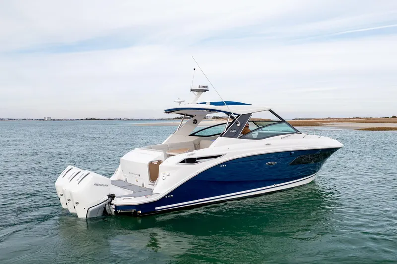 Slide: The Image of 2020 Sea Ray Sundancer 320 Outboard cruising on open water, showcasing sleek design. - 8